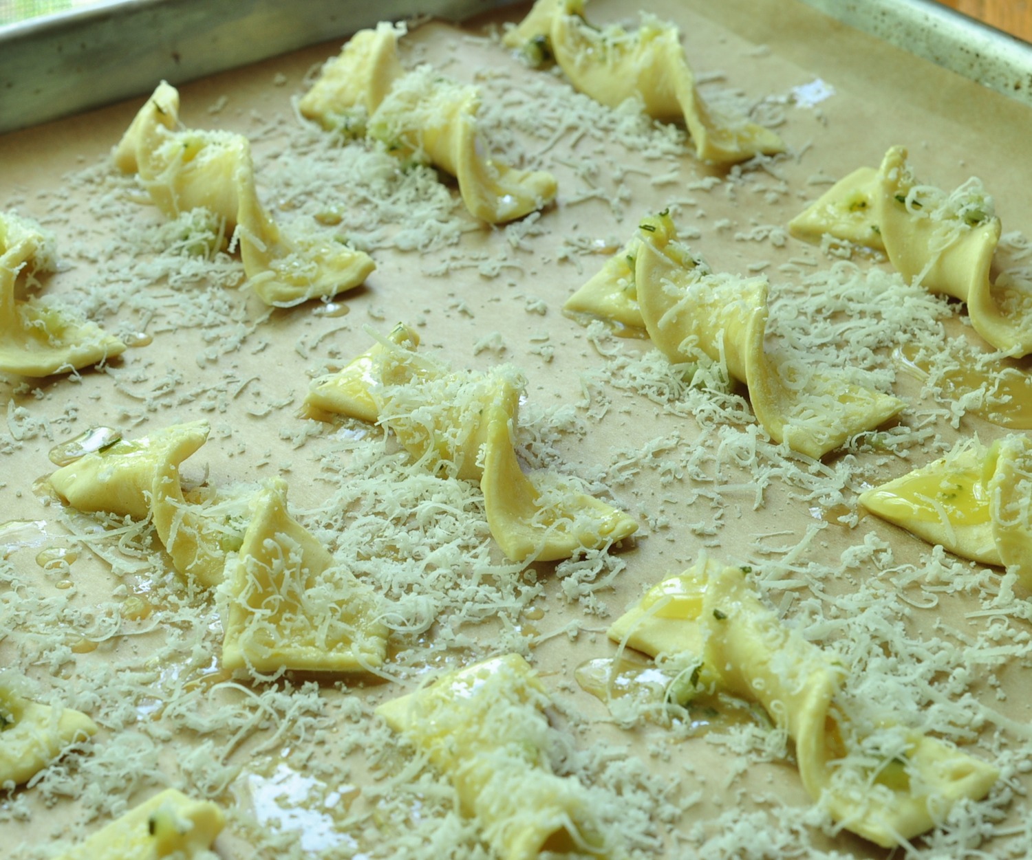 putting cheese on puff pastry rosemary garlic twists